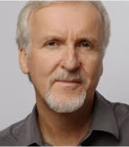The image shows a portrait of James Cameron, an elderly man with gray and white hair, wearing a pointed gray beard and mustache. He is dressed in a dark gray shirt. His expression is serious, almost grave.